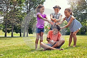 We have taken him captive. adorable children playing with water balloons outdoors.