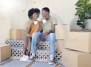 We have this to look forward to. Shot of a young couple drinking coffee while moving into their new house.