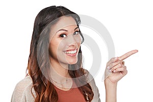 Have you seen this copyspace. Portrait of a confident young woman pointing at blank copyspace in studio.