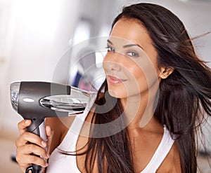 Have you tried this new hairdryer. a beautiful young woman blow drying her hair.