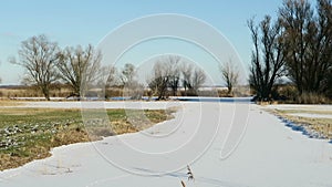 Havel river chanal with footprints of nutria river rat in snow. Havelland, Germany