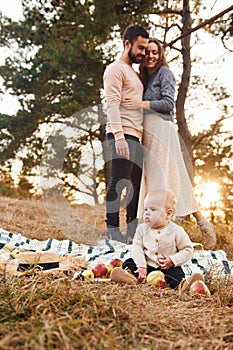 Haves picnic. Happy family of mother, family and little baby rests outdoors. Beautiful sunny autumn nature