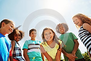 Having awesome friends means a lot. Portrait of a group of diverse and happy kids hanging out together on a bright day