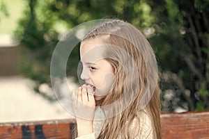 Having a bite. Cute small child eating snack food outdoor. Adorable little girl enjoying street food on summer day. Fast