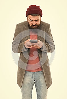 Having blog while on the go. Bearded man writing new blog post from smartphone. Blogger keeping private blog. Hipster