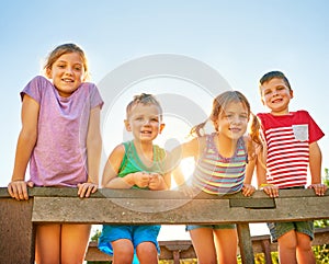 Having a bunch of fun in the summer sun. Portrait of a group of little children playing together outdoors.