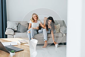 Having conversation. Two women is together at home