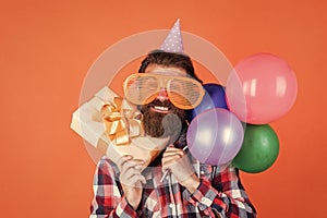 Having crazy day. summer shopping sales. feel the happiness. happy man with beard. man in party glasses hold balloons