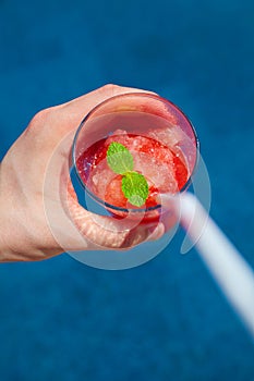 Having a fresh fruit drink by the pool
