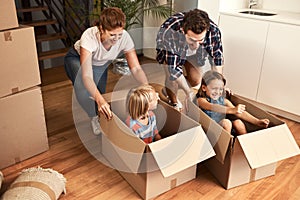 Having fun with the boxes. a young family on their moving day.