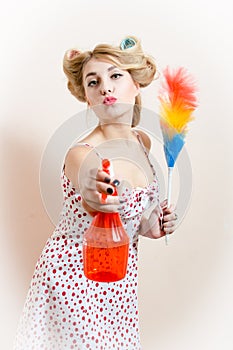 Having fun gorgeous beautiful funny young blond pinup woman splashing water, removing dust expressing kiss & looking at camera