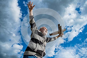 having fun. senior retired man. mature man at retirement. old man on sky background with toy plane