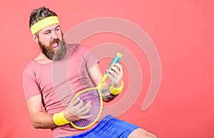Having fun. Tennis active leisure. Athlete hipster hold tennis racket in hand red background. Tennis player vintage
