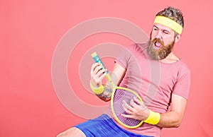 Having fun. Tennis active leisure. Athlete hipster hold tennis racket in hand red background. Tennis player vintage