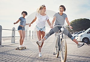 Having fun is what we do best. three friends having fun on the promenade.