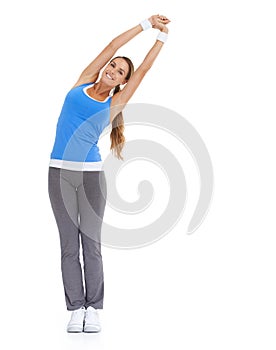 Having a good stretch. Healthy young woman in sportswear stretching while isolated on white.