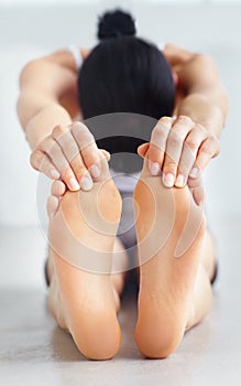 Having a good stretch. Young woman touching her toes in a stretch.