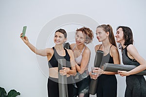 Having good time. women socialising at yoga club, taking selfie