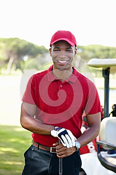 Having a great day out. Portrait of a happy young man standing on a golf course.