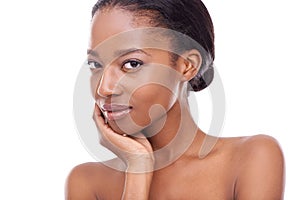 Having great skin gives me confidence. A beautiful young woman looking at the camera and touching her face.