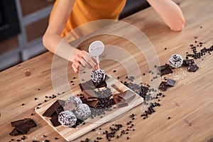Distressed curly-haired woman lying on table surface and desiring sweets photo