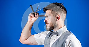 Having the right tools. Hipster with beard in razor barber shop. Bearded man with razor and scissors in retro barbershop