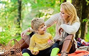 Having snack during hike. Happy childhood. Mom and kid boy relaxing while hiking forest. Family picnic. Mother pretty