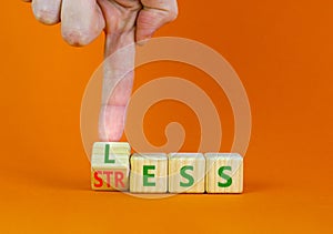 Having less stress or being stress-less symbol. Doctor turns a wooden cube and changes the concept word Stress to Less. Beautiful