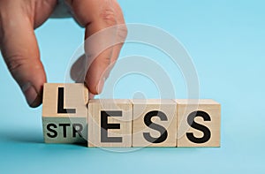 Having less stress or being stress-less. The word on wooden cubes. The concept of having less stress or being stress