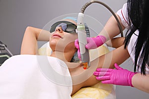Having underarm laser hair removal epilation photo