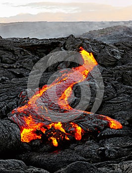 Hawaii Kilauea flowing lava in morning light