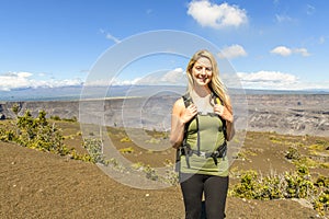 The Hawaii volcano tourist woman at Halemaumau crater in Kilauea caldera in Hawaii Volcanoes National Park