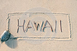 Hawaii written with sticks on the sand