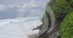 Hawaiian coastline with rocks and ocean with storm waves