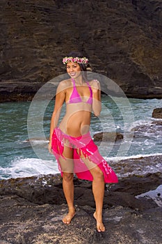 Hawaiian girl with flowers on lava