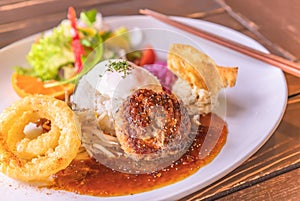 Hawaiian Loco Moko rice plate with an hamburger on a plate with chopsticks in a Japanese restaurant.