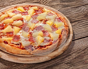 Hawaiian pizza on the old board