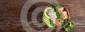 Hawaiian poke coconut bowl with grilled salmon fish, rice and avocado. Healthy food