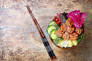 Hawaiian salmon poke bowl with seaweed, watermelon radish, cucumber, pineapple and sesame seeds. Copy space