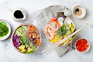 Hawaiian salmon and shrimp poke bowls with seaweed, avocado, mango, pickled ginger, sesame seeds.