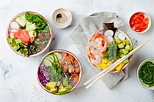 Hawaiian salmon, tuna and shrimp poke bowls with seaweed, avocado, mango, pickled ginger, sesame seeds.