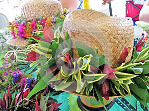 Hawaiian straw hats decorated with traditional flower leis