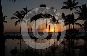 Hawaiian summer sunset over the ocean and tranquil pond as seen from Maui