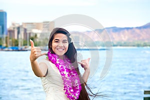 Hawaiian teen with lei making hang loose sign, Waikiki, Honolulu