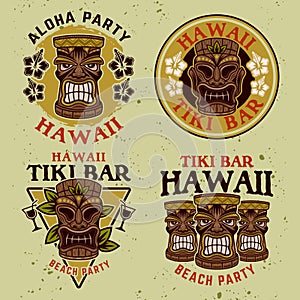 Hawaiian tiki wooden head set of four vector colorful emblems, badges, labels, stickers or logos in cartoon style on