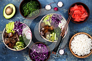 Hawaiian tuna poke bowl with seaweed, avocado, red cabbage, radishes and black sesame seeds. photo