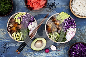 Hawaiian tuna poke bowl with seaweed, avocado, red cabbage slaw, radishes and black sesame seeds.