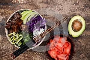 Hawaiian tuna poke bowl with seaweed, avocado, red cabbage slaw, radishes and black sesame seeds.