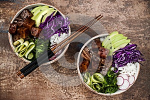 Hawaiian tuna poke bowl with seaweed, avocado, red cabbage slaw, radishes and black sesame seeds.