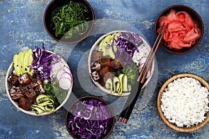 Hawaiian tuna poke bowl with seaweed, avocado, red cabbage slaw, radishes and black sesame seeds.